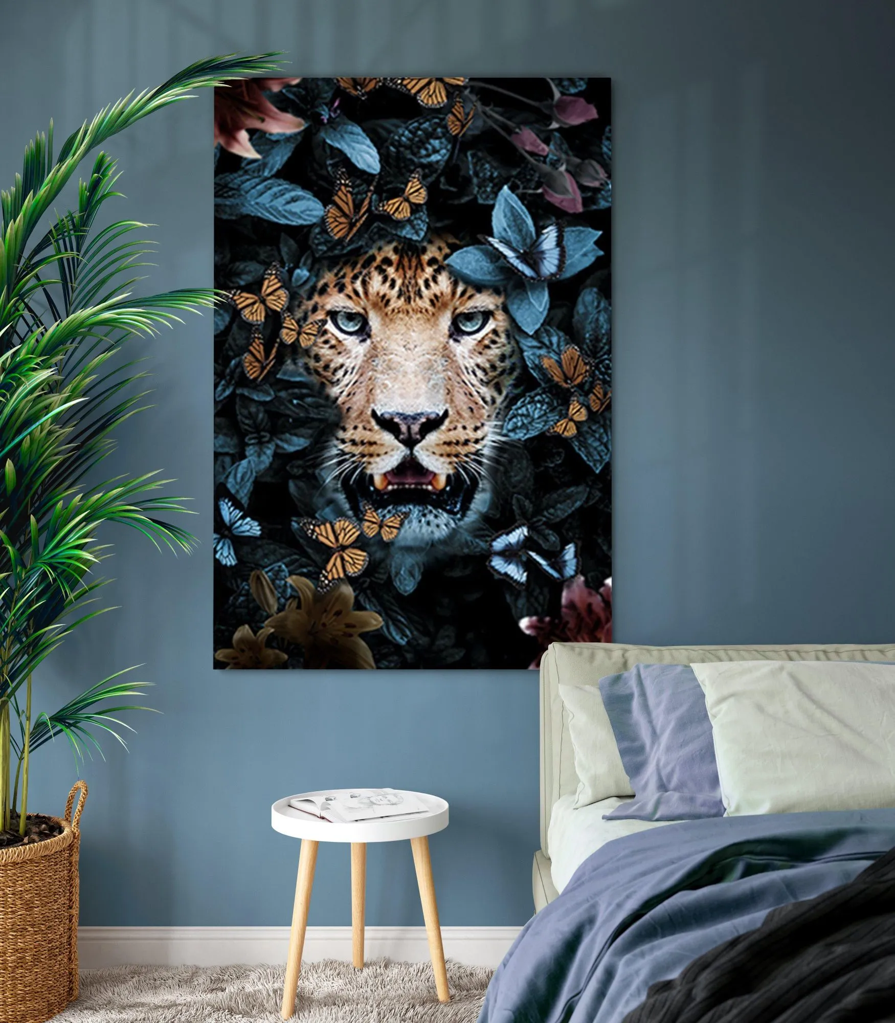 The Leopards Gaze canvas, a leopard among dark leaves and butterflies, hanging above a bed